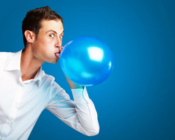 Portrait Of Young Man Blowing Balloon — Stockfoto